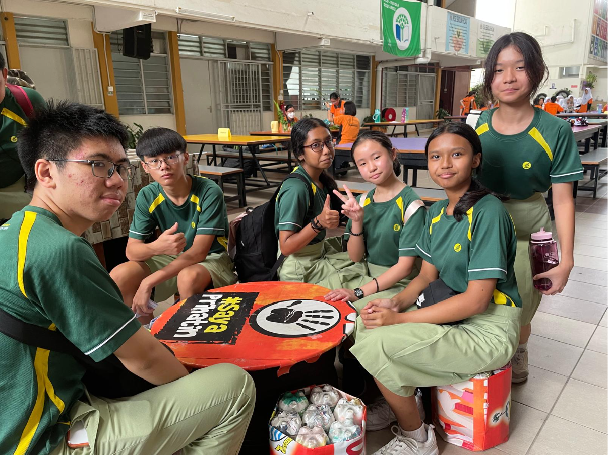 Pasir Ris Secondary School students seating surrounding street art.